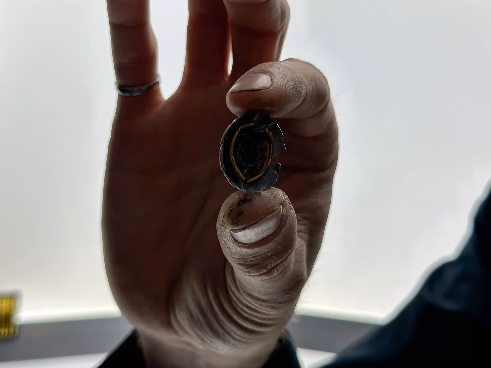 James Hacksmith wearing John Wick's bulletproof jacket, showing bullet closeup