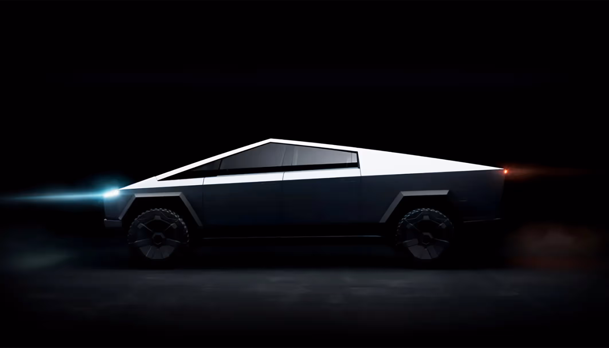 Tesla Cybertruck in the dark with the lights on
