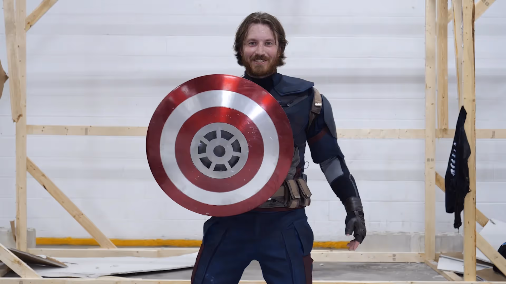 James with Captain's America shield, smiling