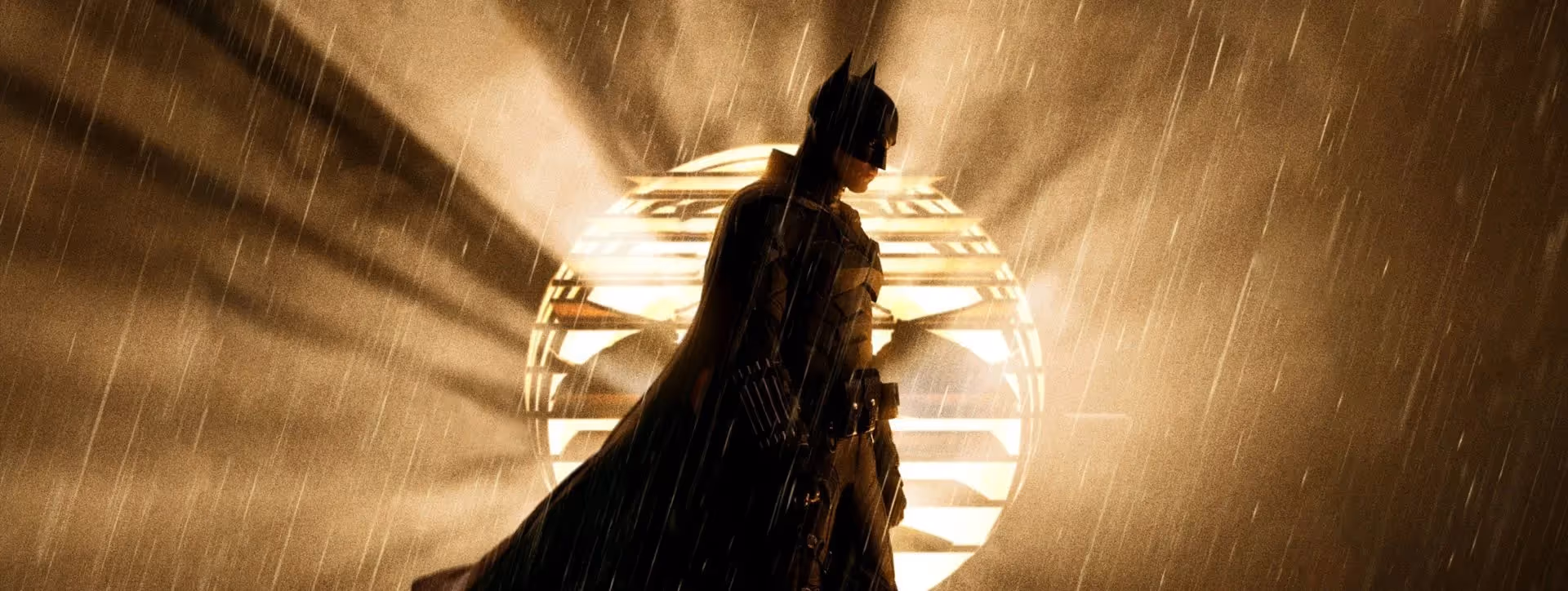 Batman standing in front of the bat signal