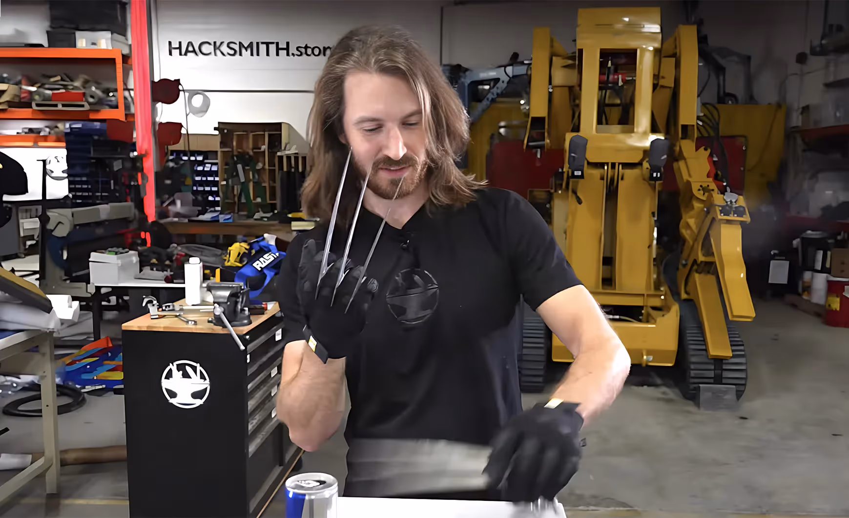 James with wolverine claws moving things on a desk