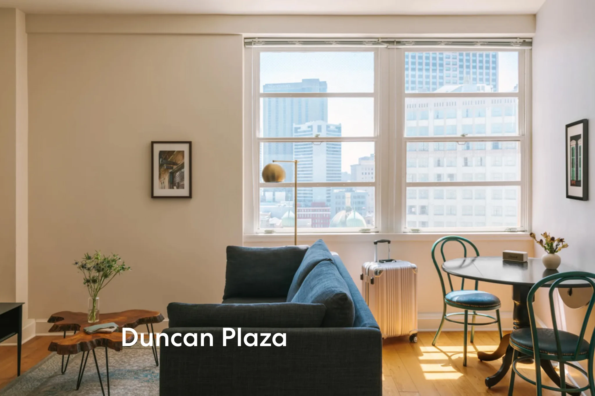 living room with navy sofa and city view window at duncan plaza in new orleans