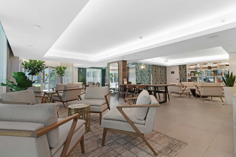 bright lobby lounge with armchairs and plants