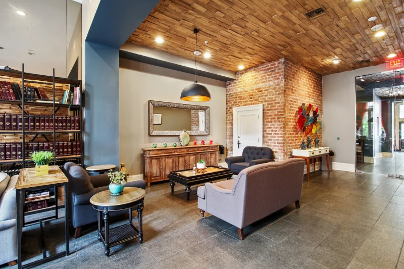 building lobby lounge with wood ceiling brick wall and seating area