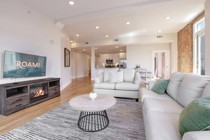 living room with sectional sofa fireplace and tv in a roami apartment