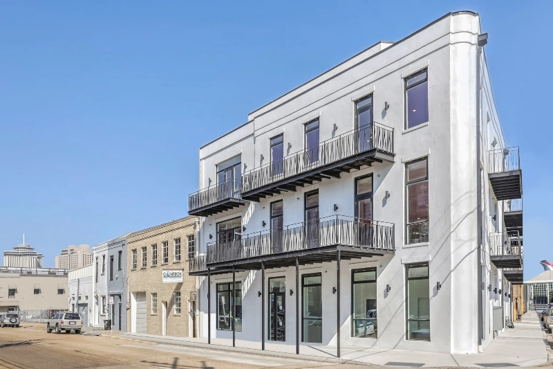 white apartment building with iron balconies in new orleans