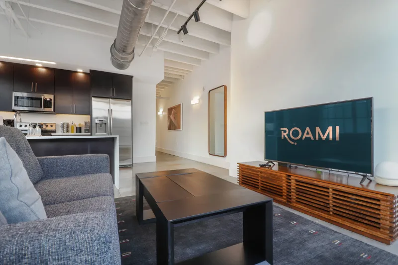 living room with grey sofa and tv at motorworks by roami