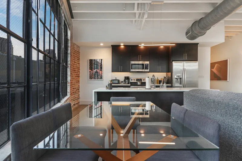 open plan loft kitchen and glass dining table at motorworks by roami