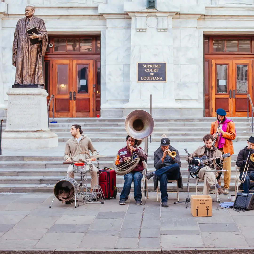 street musicians playing brass instruments on building steps in new orleans