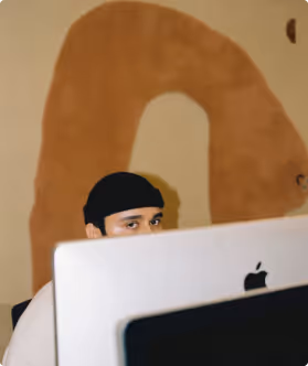 a man sitting in front of a laptop computer