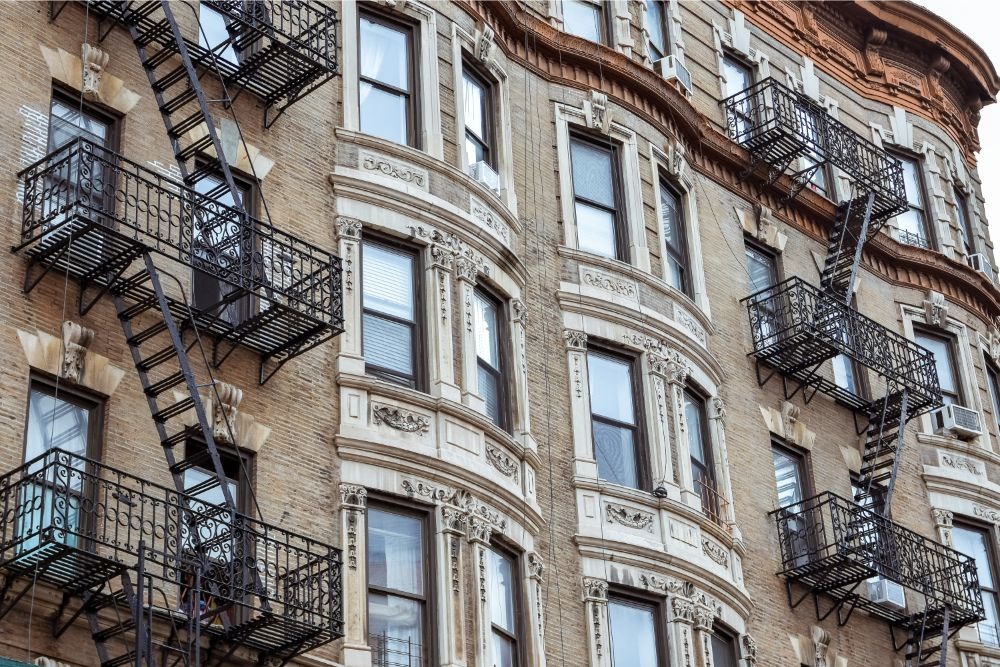 Rent-stabilized apartments in building with fire escapes in a Manhattan neighborhood