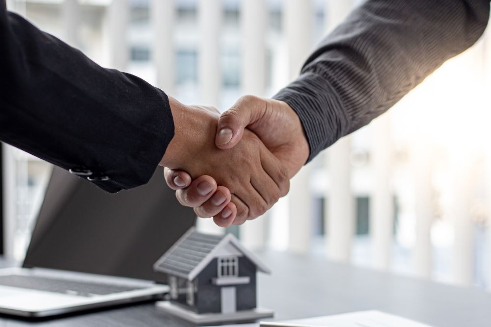 Shaking hands after negotiating a lease apartment buyout in NYC