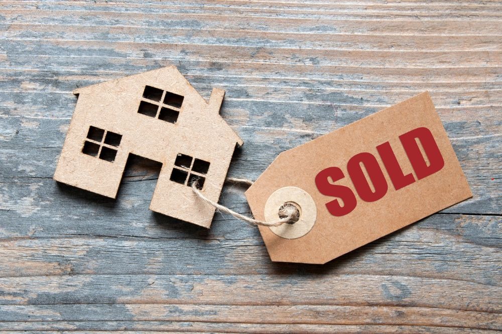  Miniature house with SOLD tag illustrates what happens when a rent-stabilized building is sold in NYC