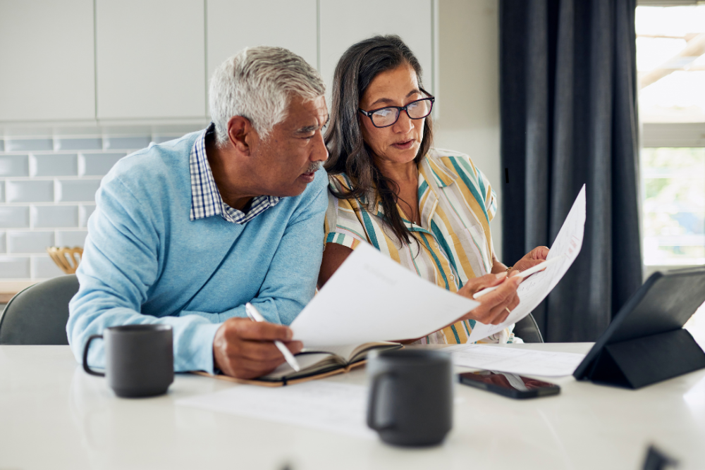 Tenants looking over an apartment buyout agreement document - Lease Buyout Advisors