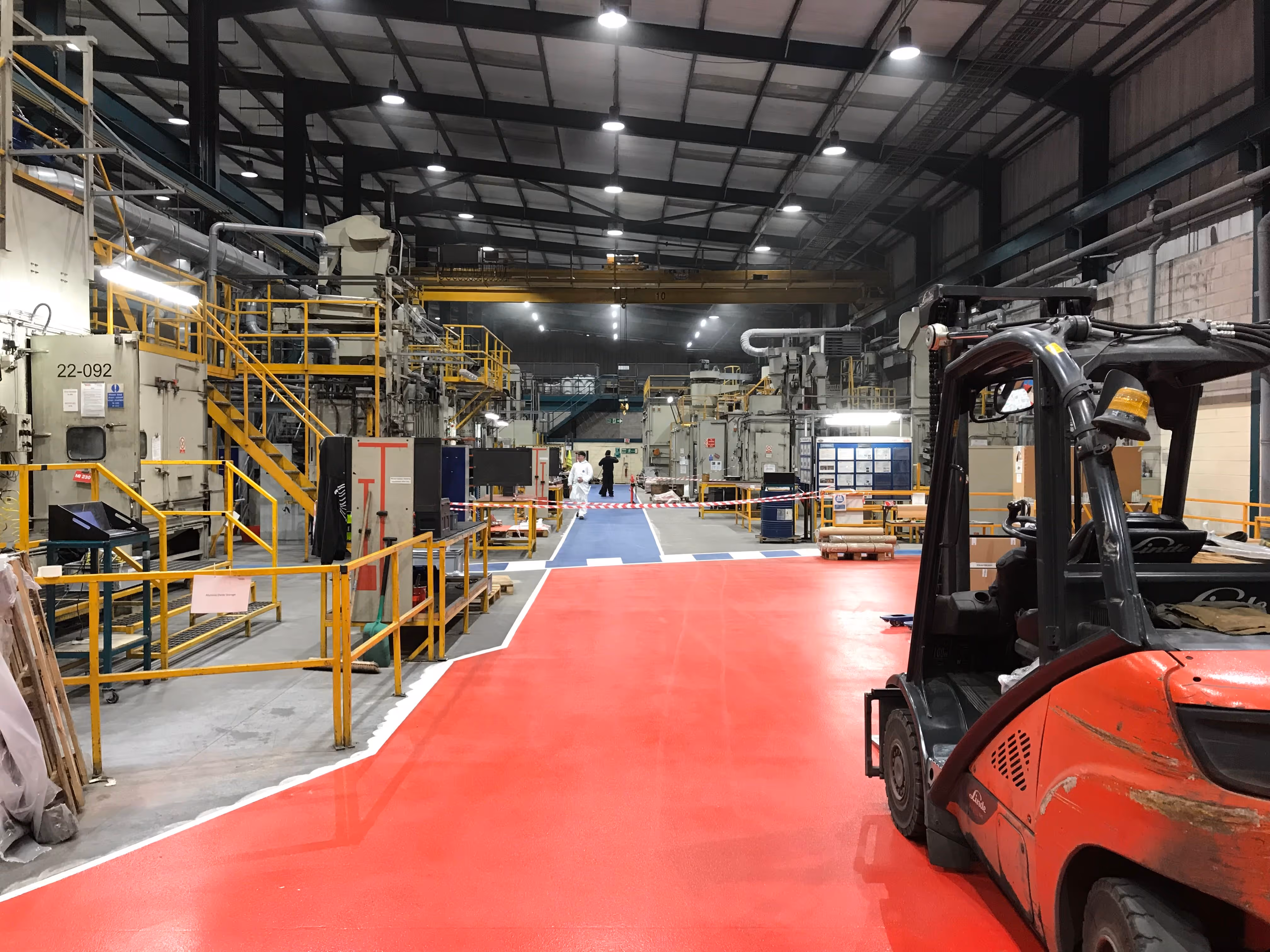 Industrial flooring with painted walkways for a factory floor