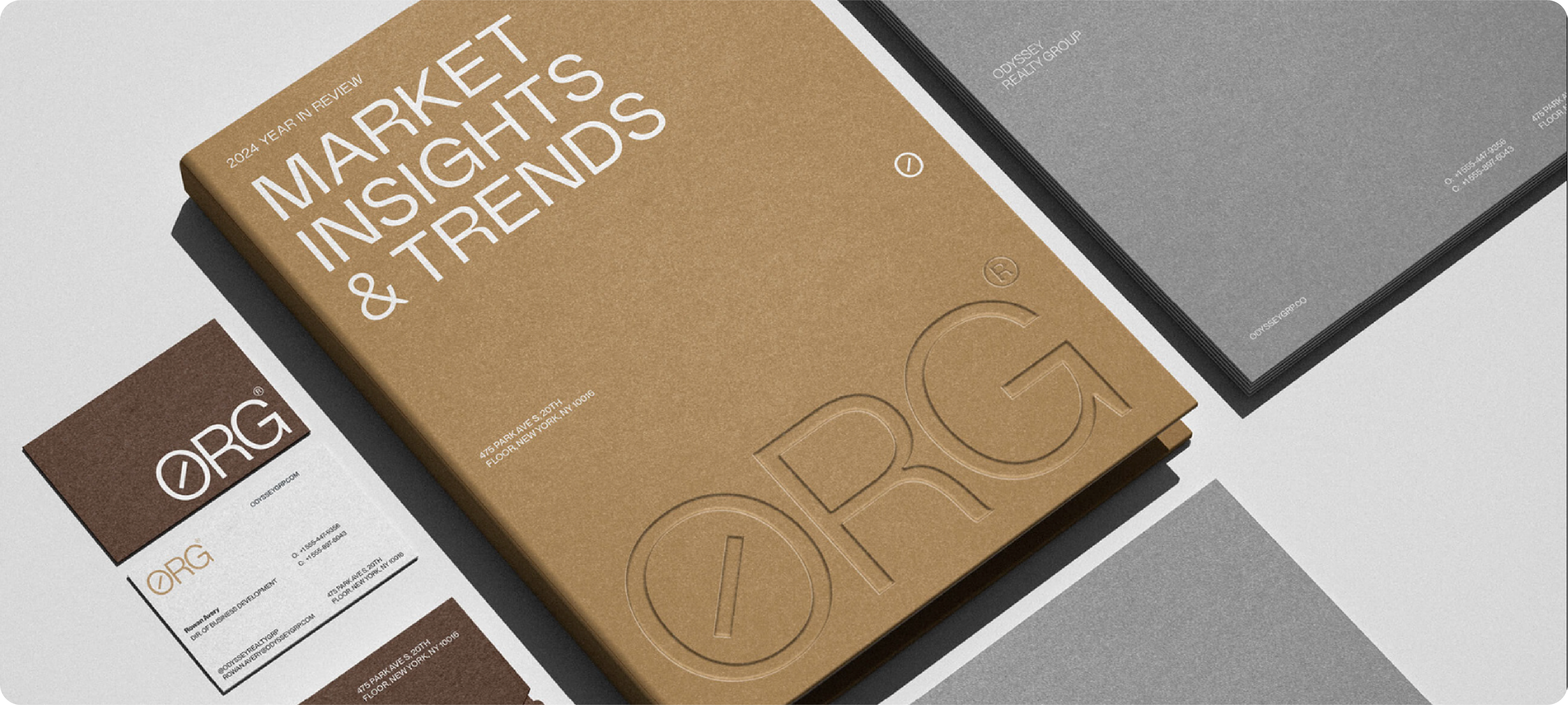 A logo presentation example for ORG, showing a brown report cover and business cards with an embossed, professional logo.