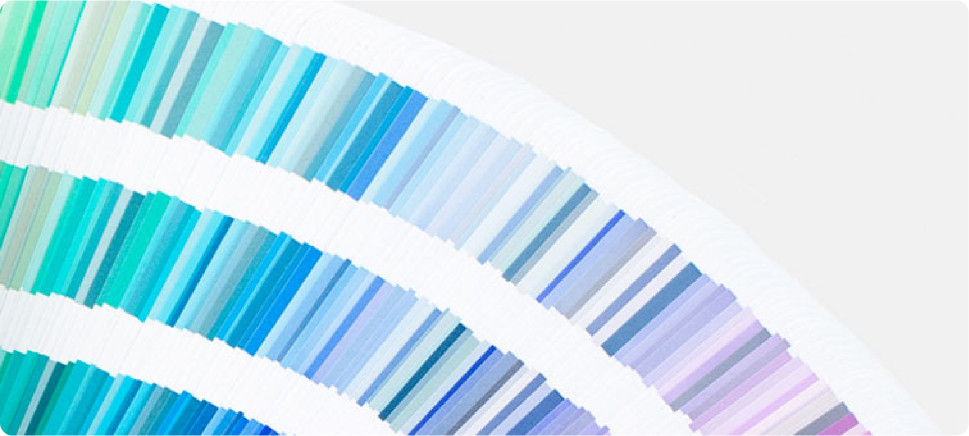 A fanned-out book of Pantone color swatches, representing the CMYK to Pantone conversion script.