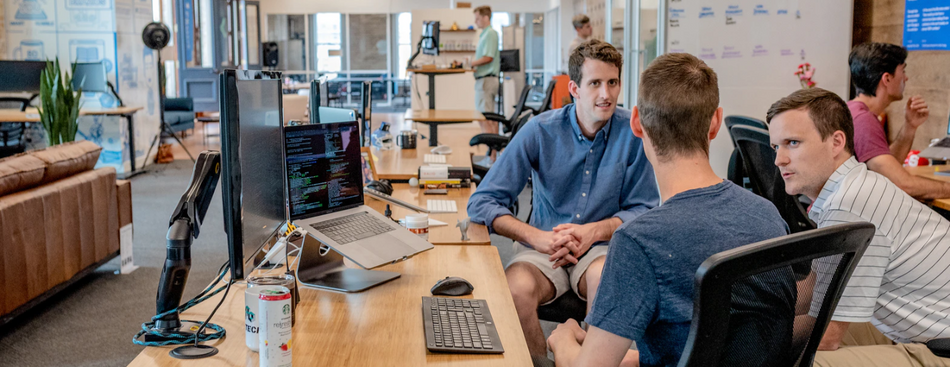 People collaborating at a desk.png