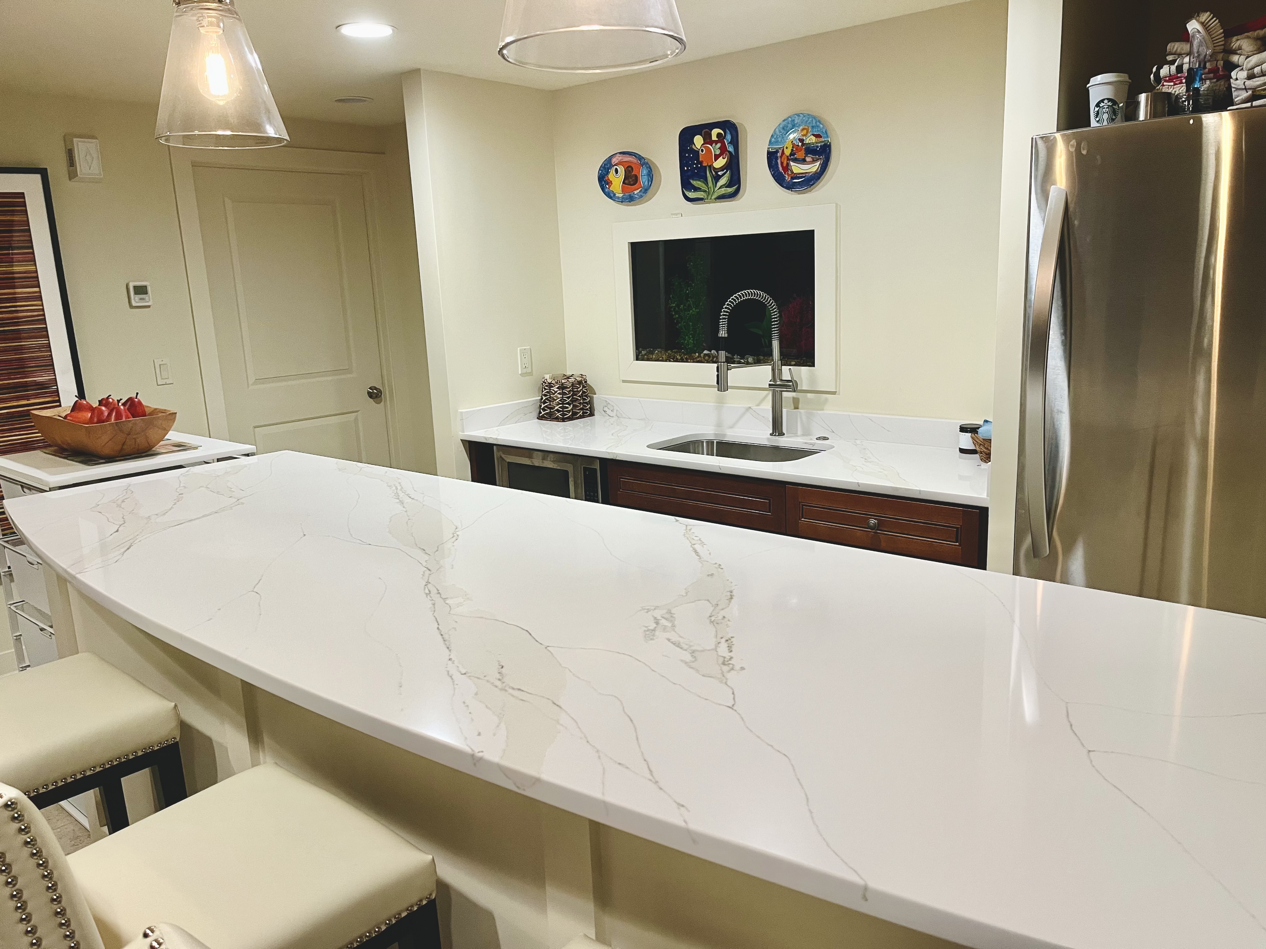 Basement Bar Refresh: White quartz bar countertop with arced edge profile in West Des Moines, IA - Quartz Impressions
