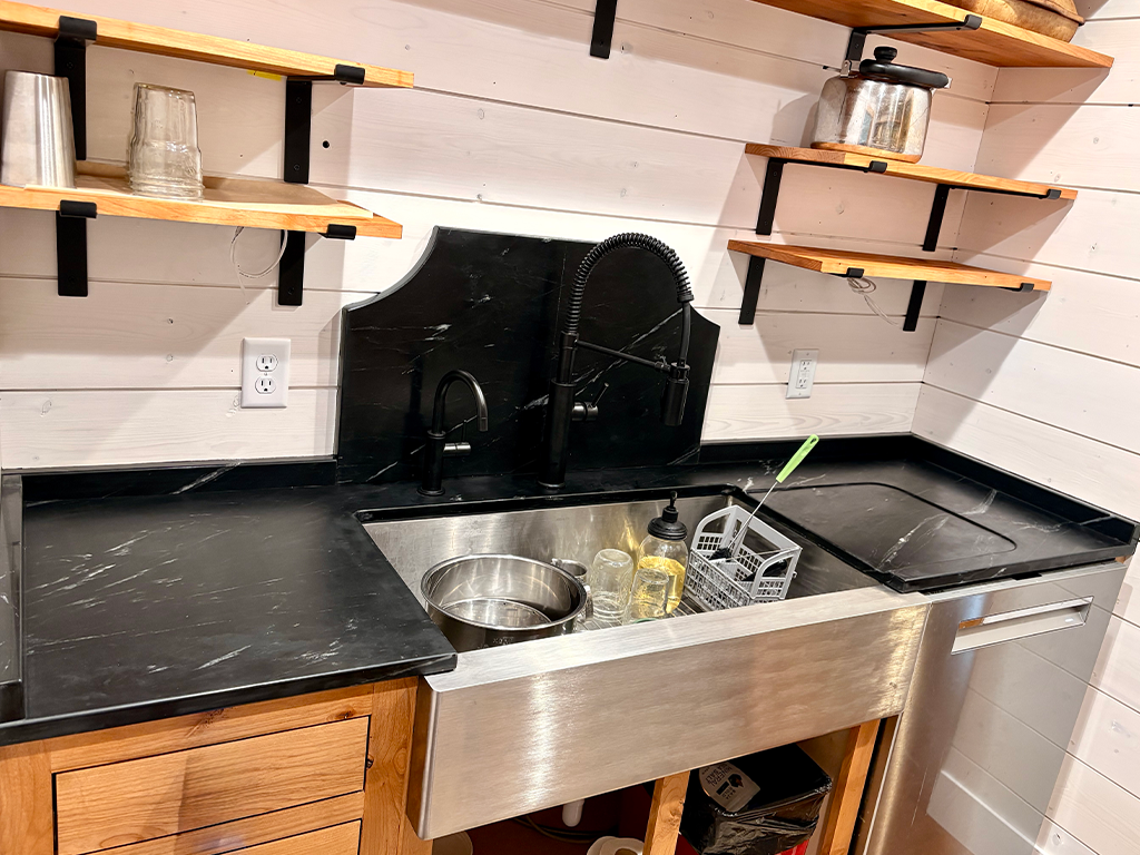 Custom Fabrication Elements: Black soapstone kitchen countertop with custom carved drainboard in Audubon, IA - Quartz Impressions