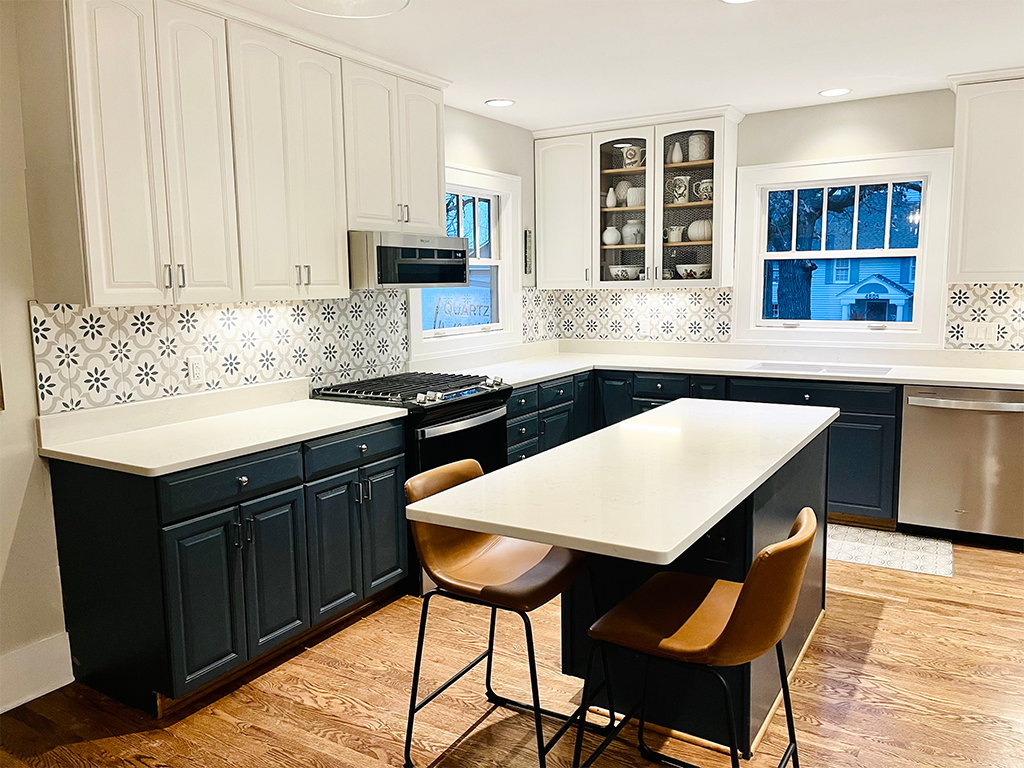 Classic Marble-Look Island: Marble-look quartz kitchen island with navy cabinetry in Des Moines, IA - Quartz Impressions