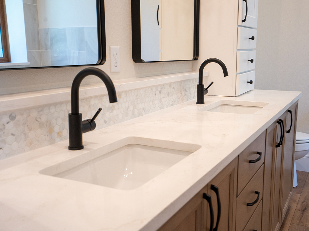 Contemporary Double Vanity: White quartz double bathroom vanity with matte black fixtures in Northwest Iowa - Quartz Impressions