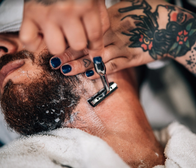 man, beard being cut with razor