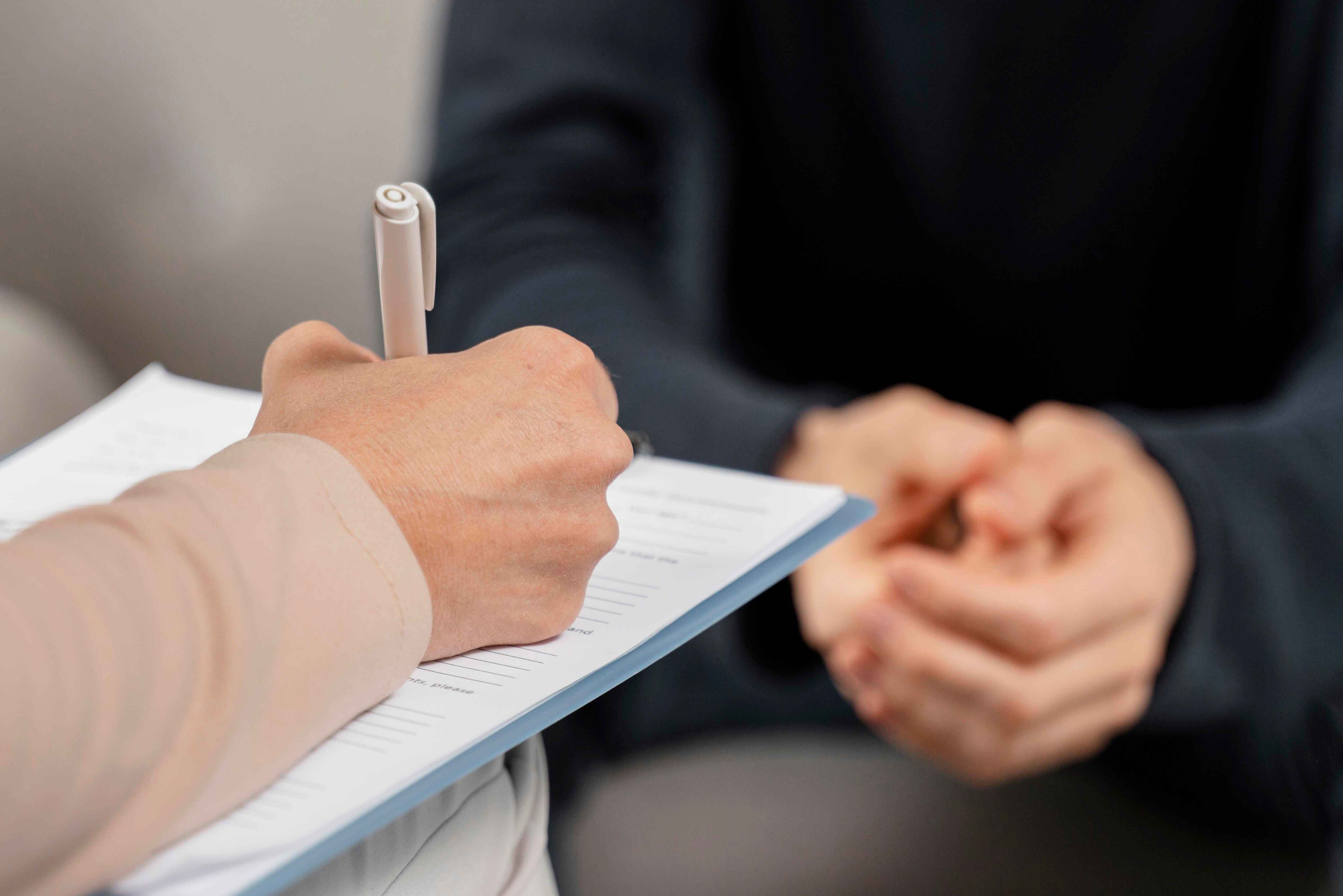 Therapist taking notes during a counseling session