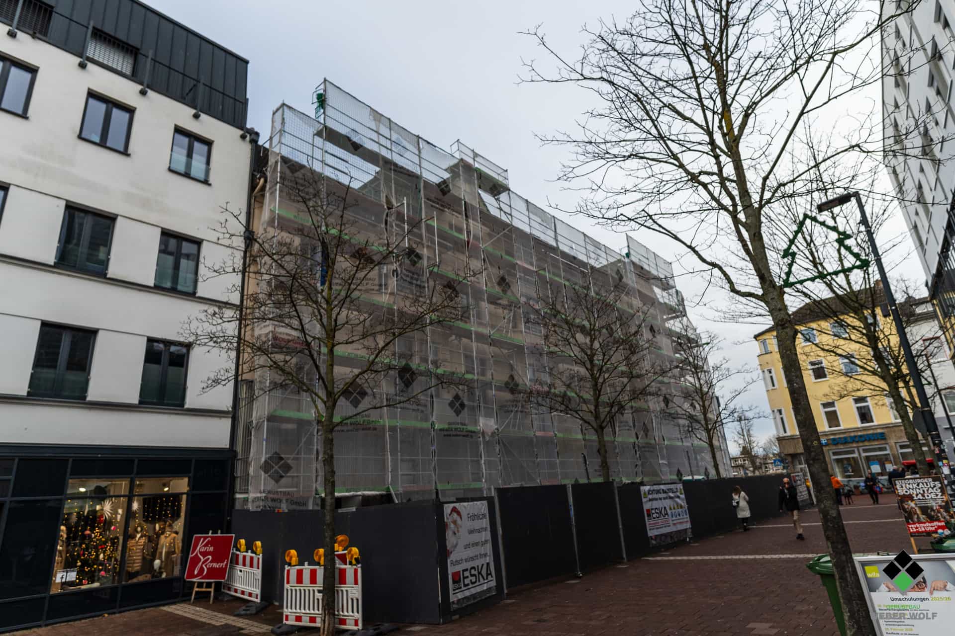 Blick von der Straße auf ein Wohngebäude in Siegburg das abgerissen werden soll und dafür ein Gerüst vom Weber Wolf Gerüstbau stehen hat.