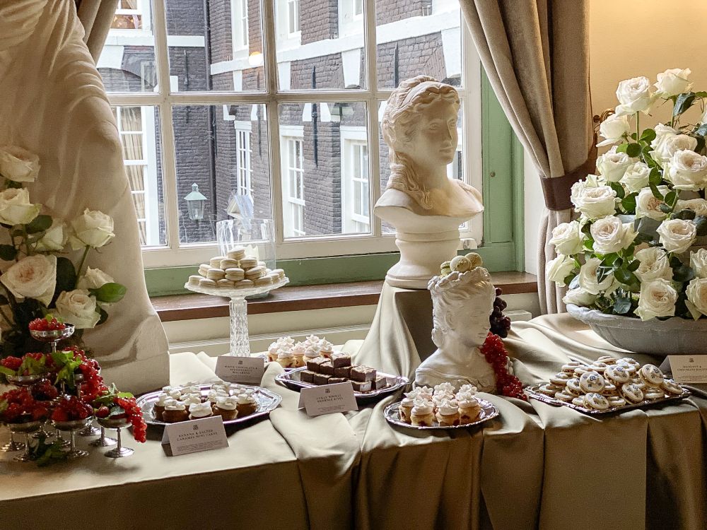 a roman table set tup displaying a beautifully arranged sweet buffet