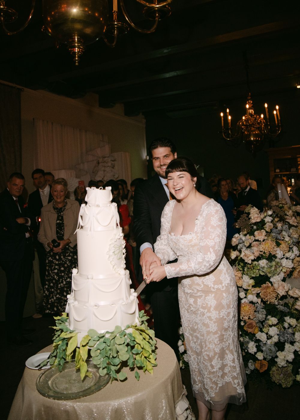 Happy couple cutting into their wedding cake at Het West-Indisch Huis