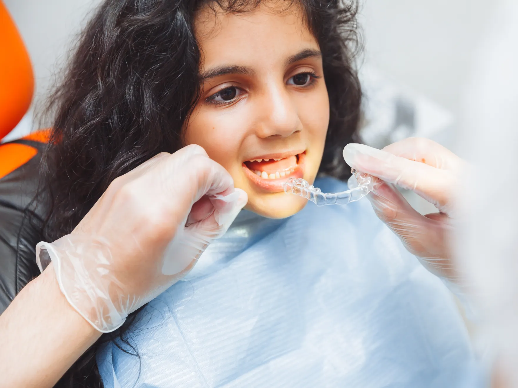 Girl trying on clear aligners