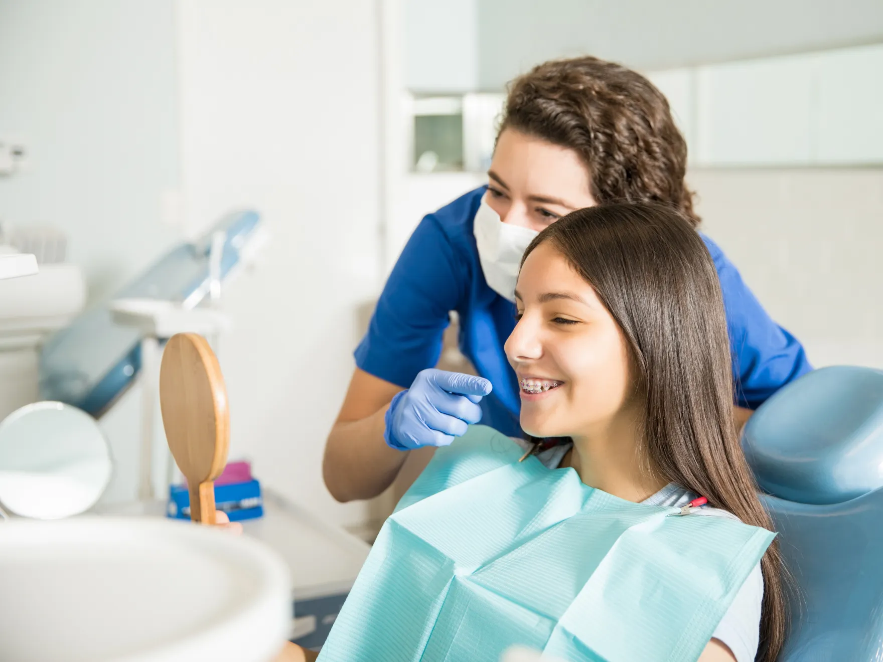 Girl looking at orthodontic treatment in the mirror