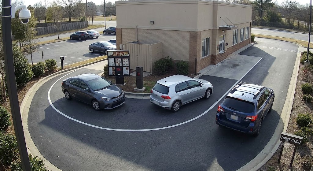 Calm off-peak drive-thru queue with only three cars waiting