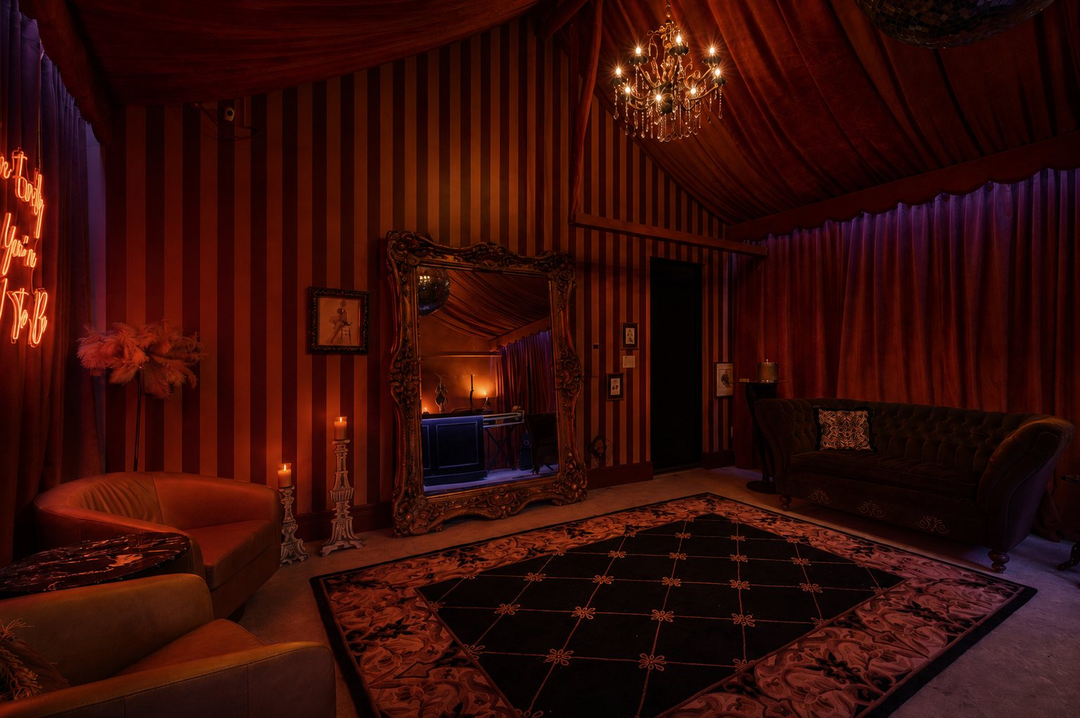 Speakeasy lounge with leather chairs, gilded mirror, and velvet tent ceiling