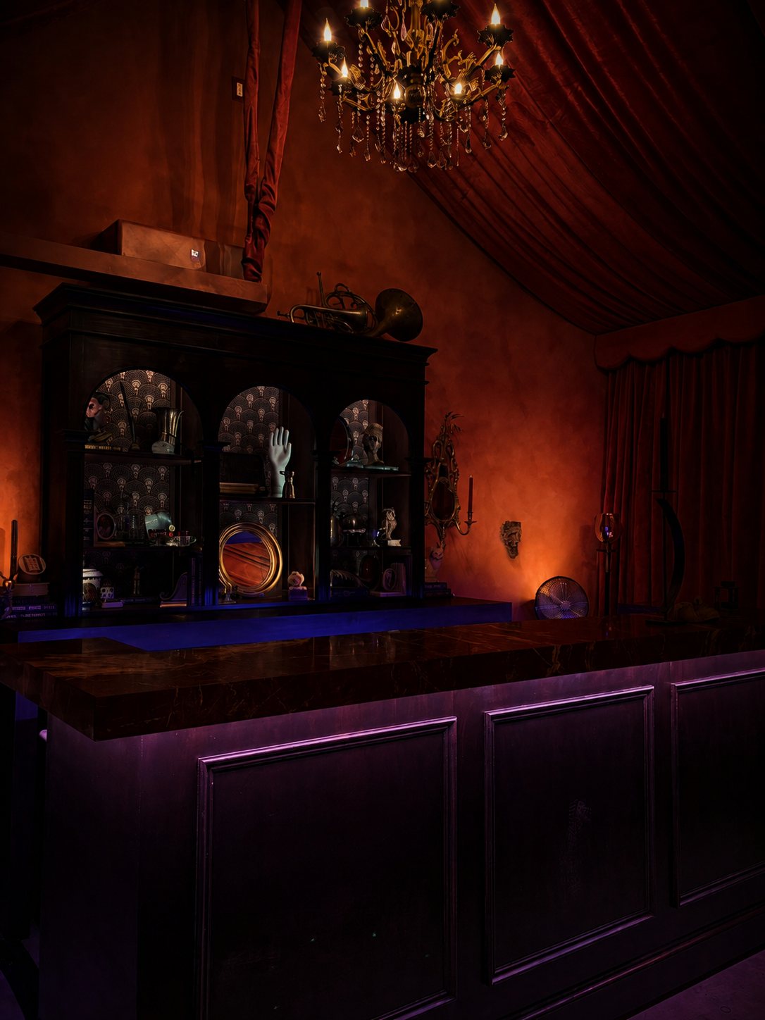 Speakeasy seating area beneath crystal chandeliers