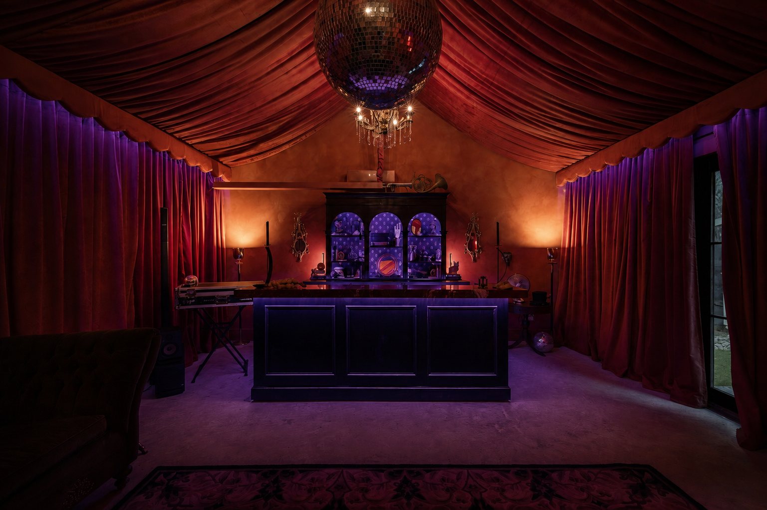 The speakeasy bar framed by red velvet drapes