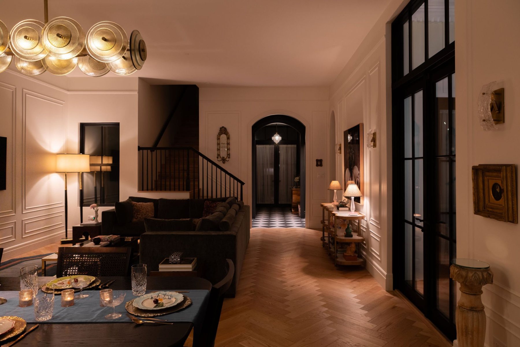 Candlelit dining table looking into the living room and staircase
