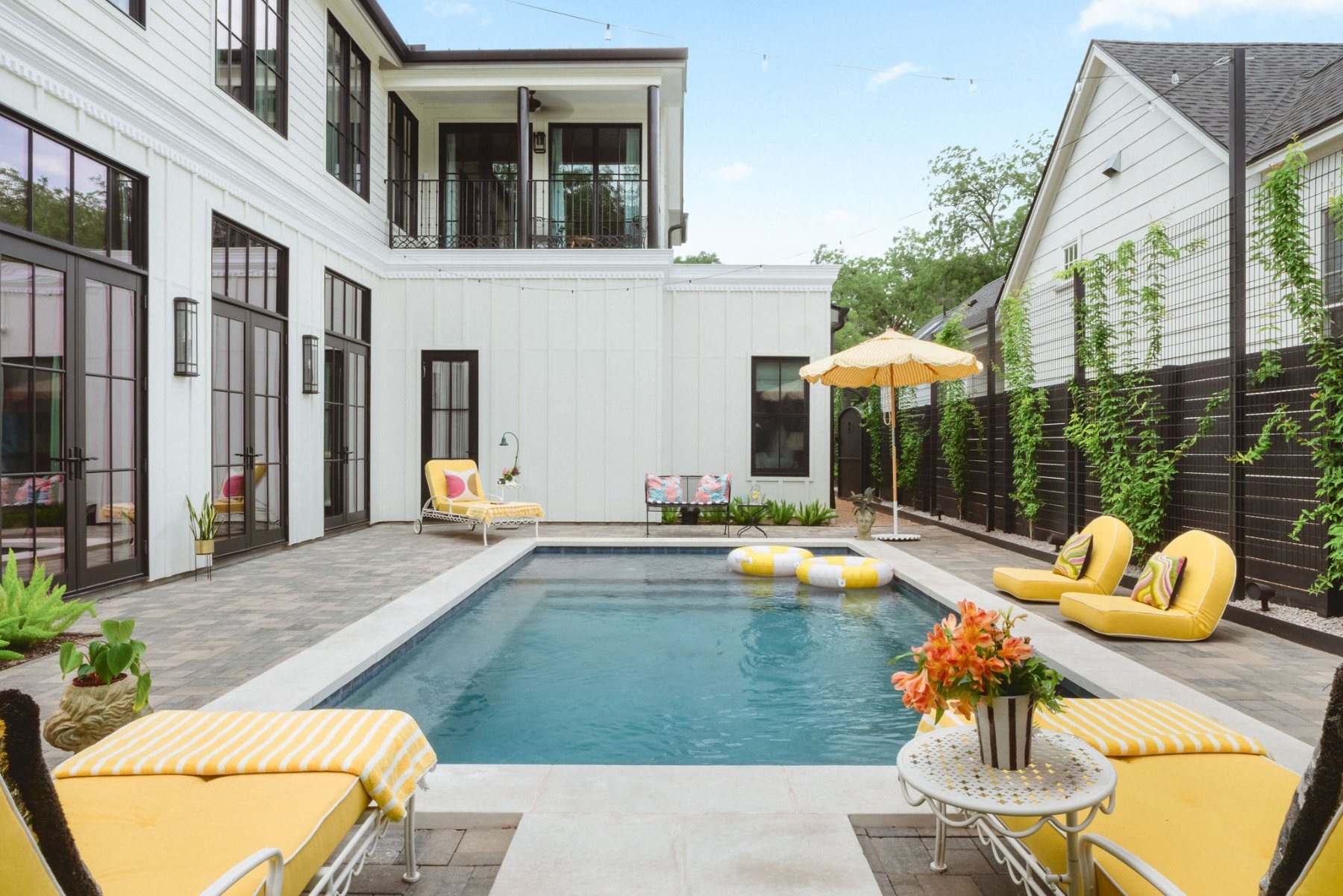 Courtyard pool with yellow loungers and umbrellas
