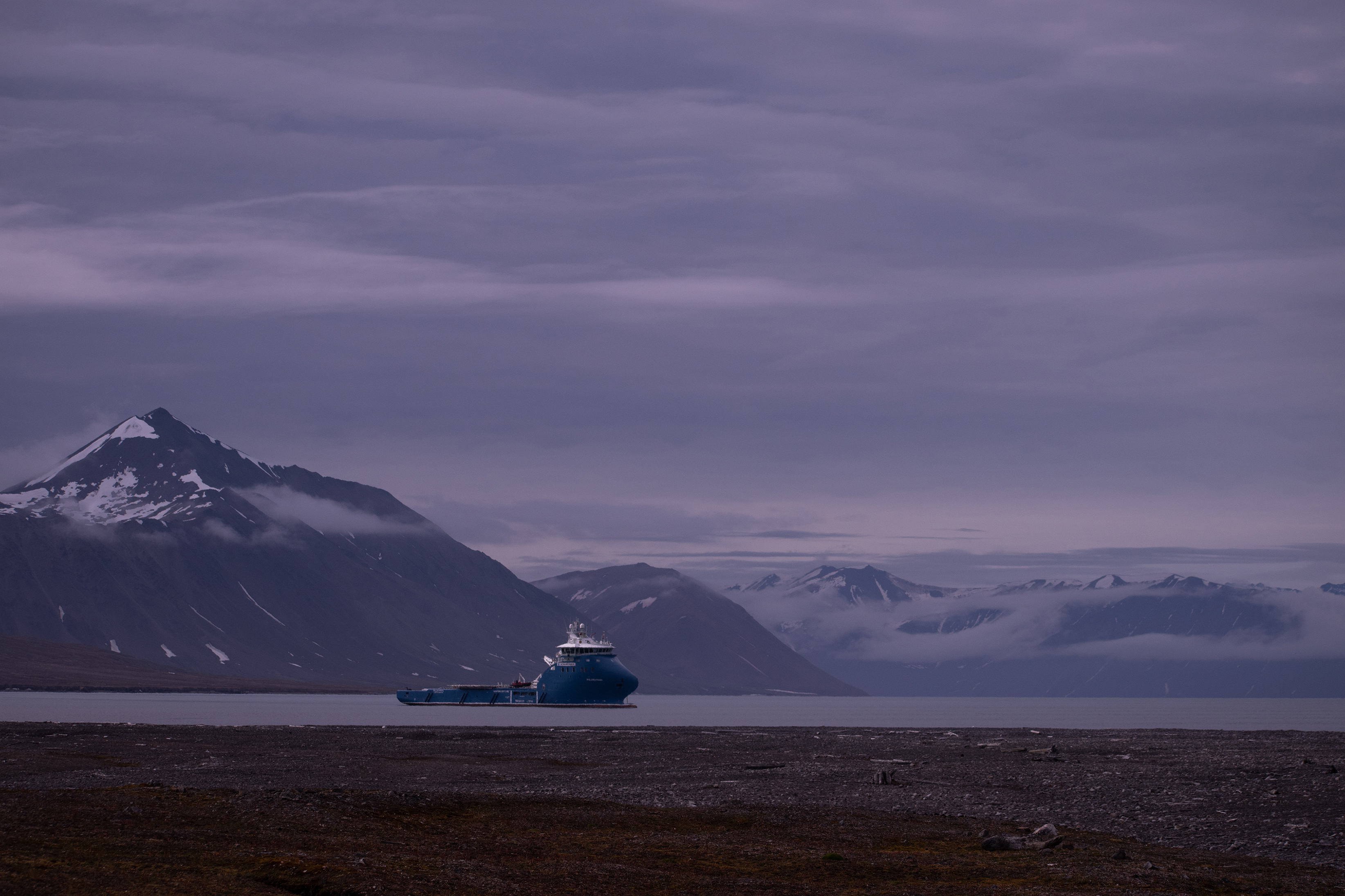 The expedition ship in a misty Arctic fjord