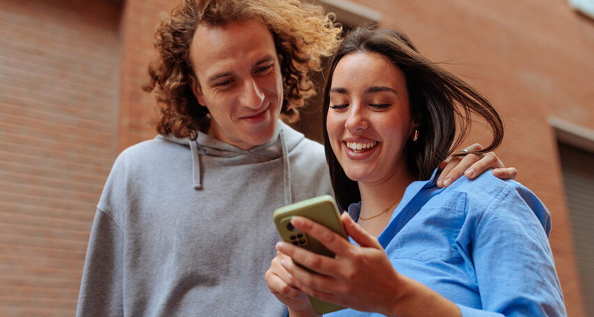 Couple looking at phone during telehealth consult.