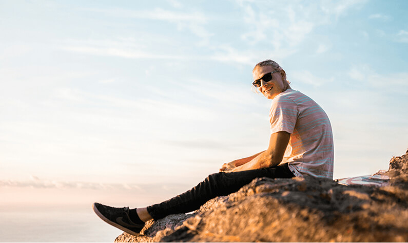 Person sitting outdoors in sunshine