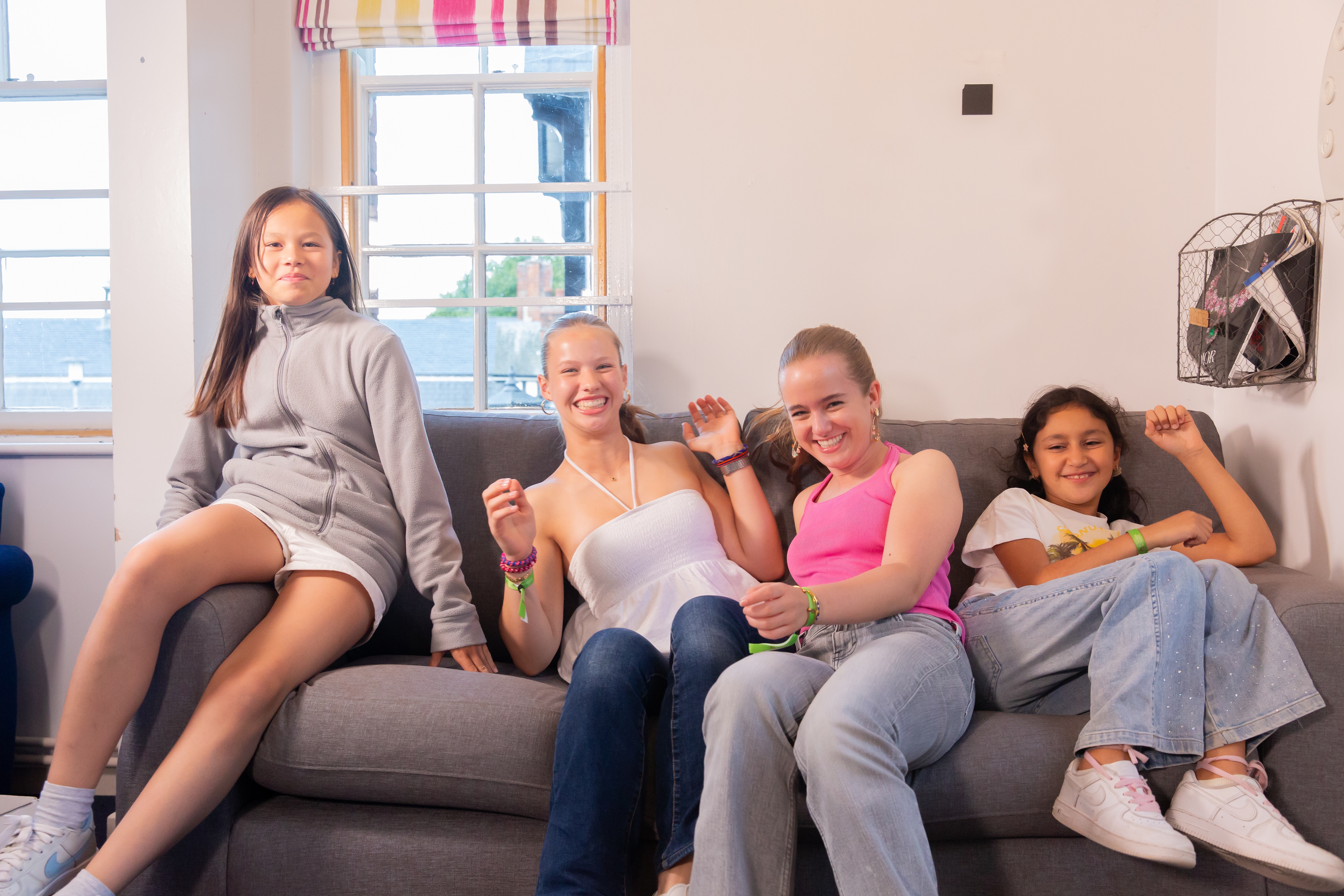 Summer School students at Malvern College relaxing and laughing together in a common room.