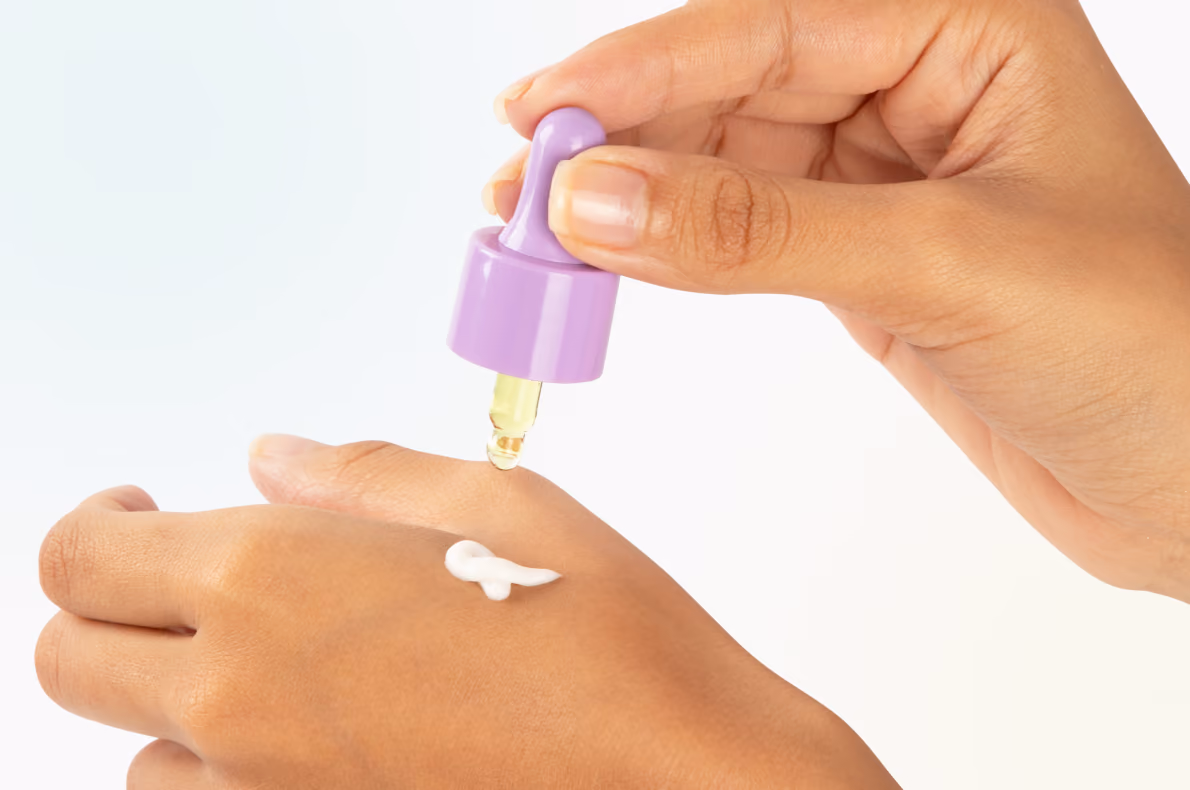 A Drop's pipette being added to Regimen Lab's moisturizer