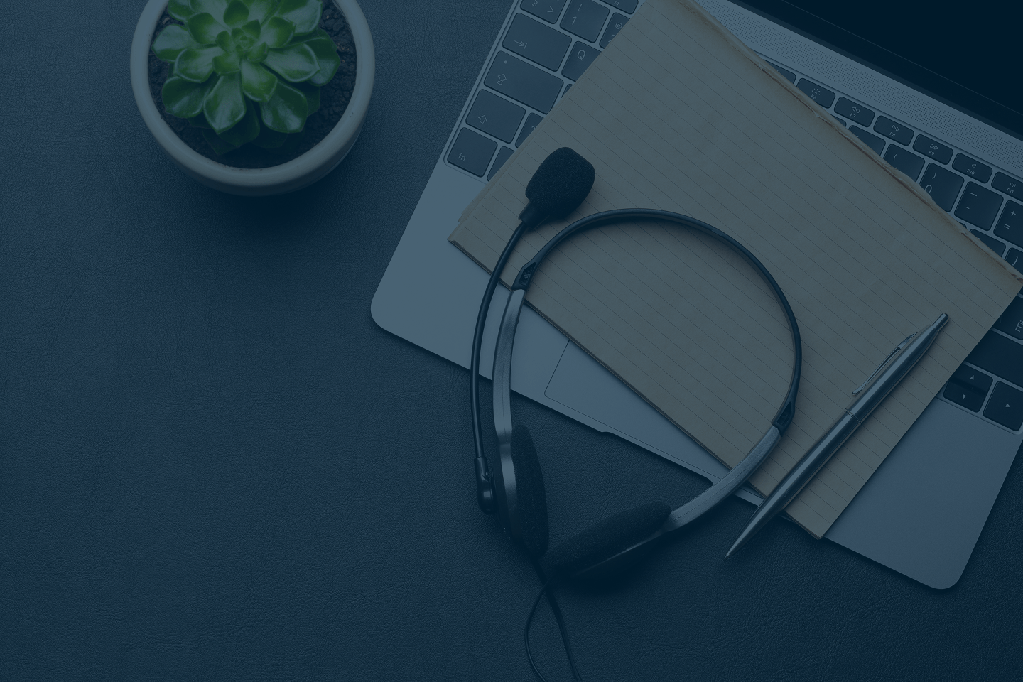 A pair of headphones sitting on a laptop 