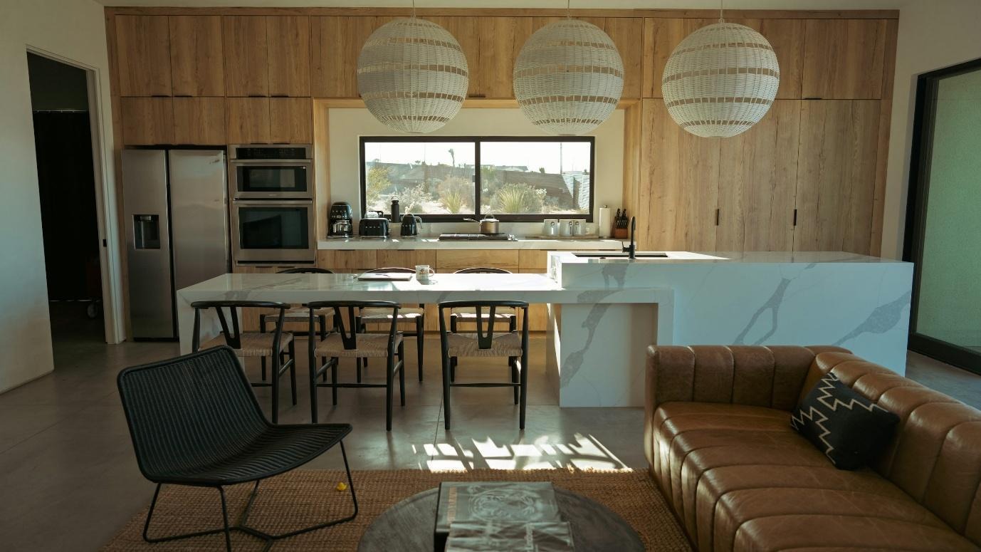Modern kitchen and living area with island seating.
