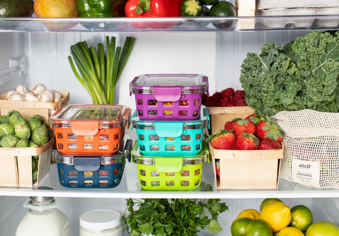 A home cook organizing fresh ingredients in a fridge