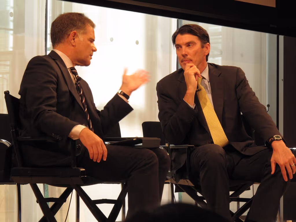 Two men in suit speaking with each other