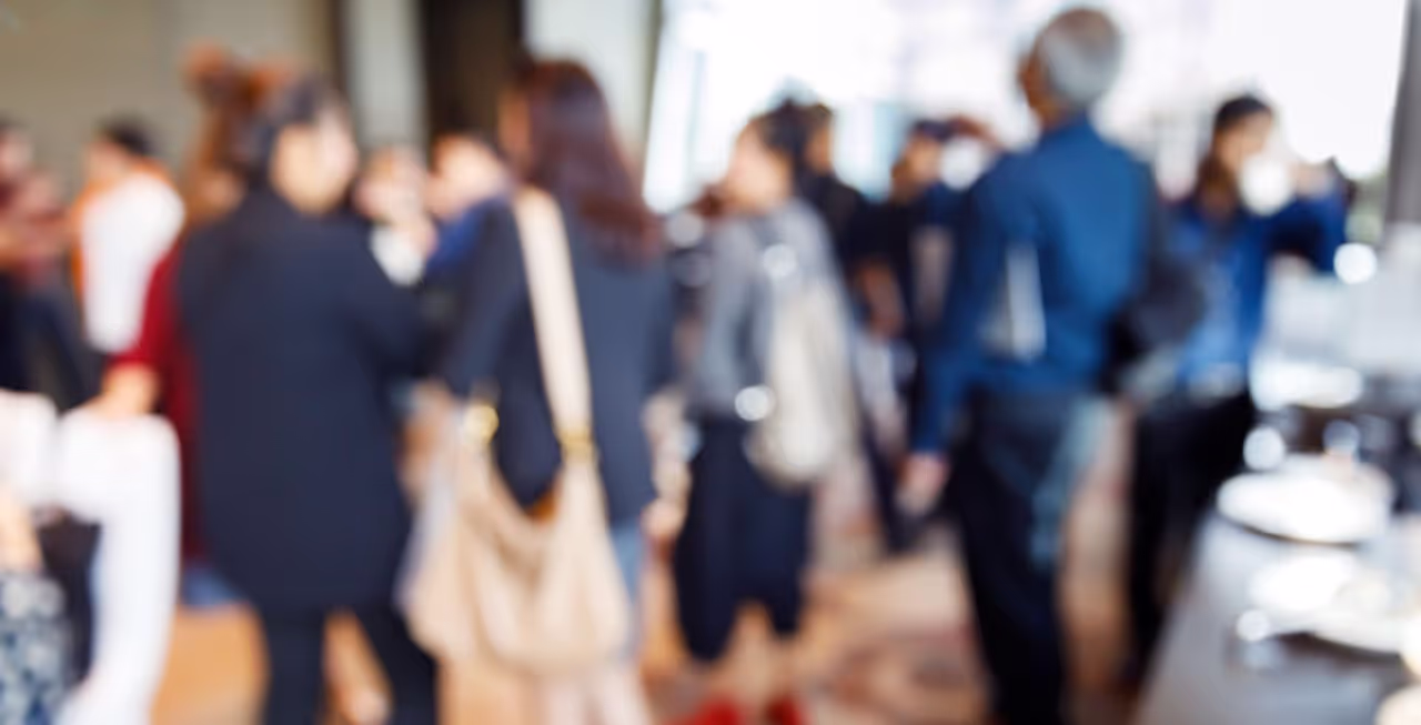 A blurred photo with group of professional people networking