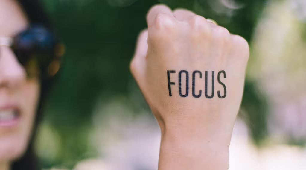 Women's fist with 'FOCUS' written on it